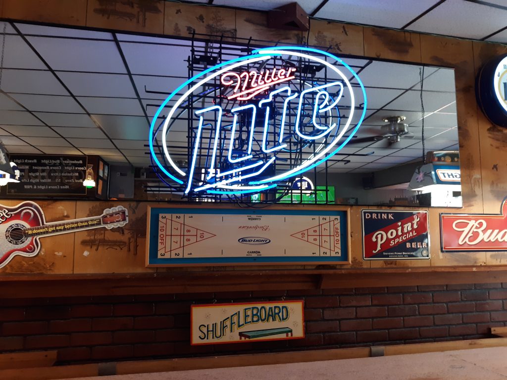 Miller Light sign next to shuffleboard table